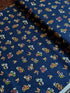 Navy cotton fabric featuring delicate floral blossoms and butterflies scattered throughout, from the Japanese Garden collection by Maywood Studio.