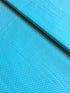 Aqua blue cotton fabric featuring small white polka dots in an all-over pattern by Robert Kaufman Fabrics, ideal for quilting, sewing, nursery décor, and craft projects.
