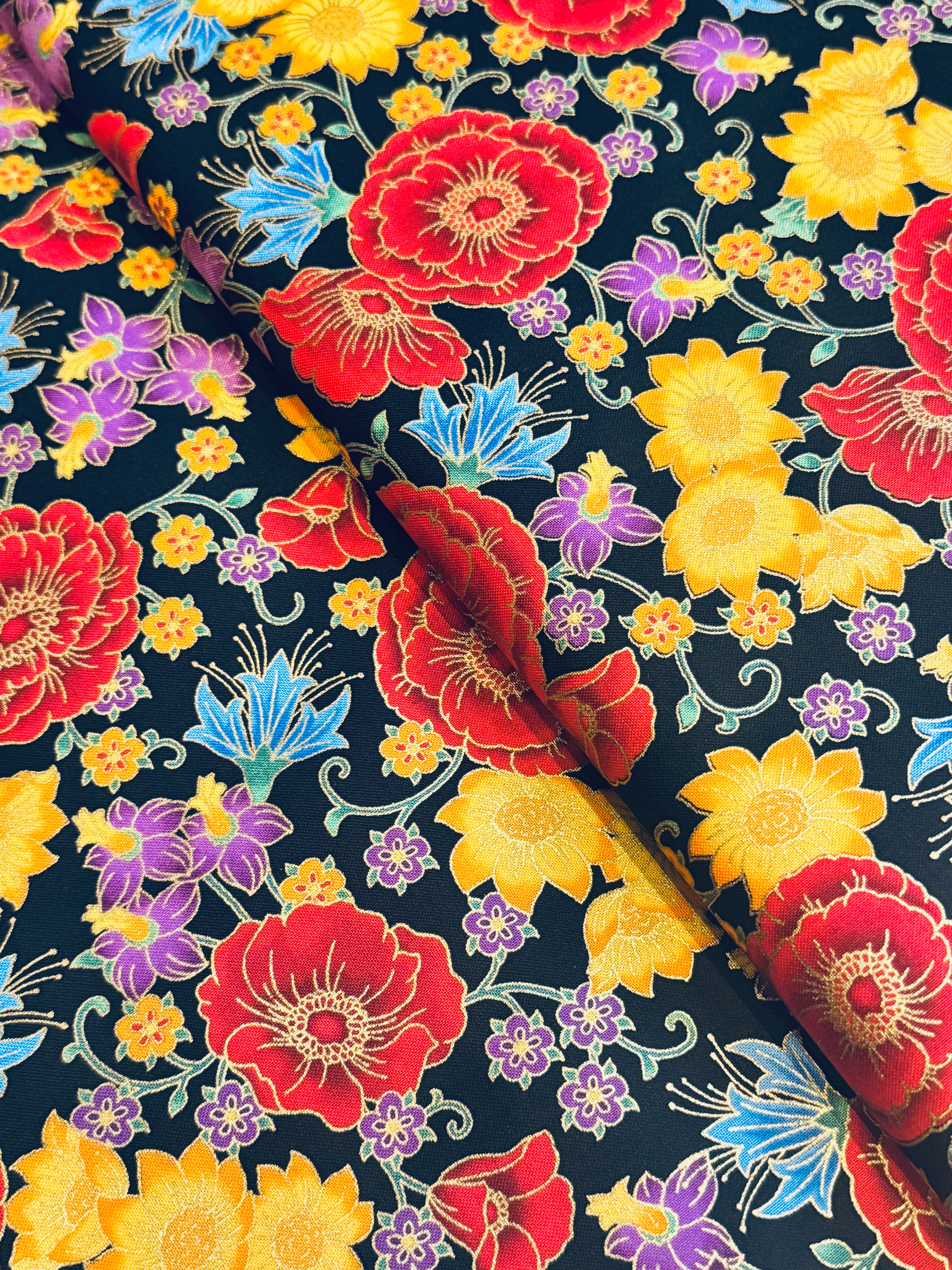 Florentine Garden Floral Multi Metallic cotton fabric by Hyun Joo Lee for Robert Kaufman featuring vibrant red, gold, purple, and blue flowers with metallic accents on a black background.