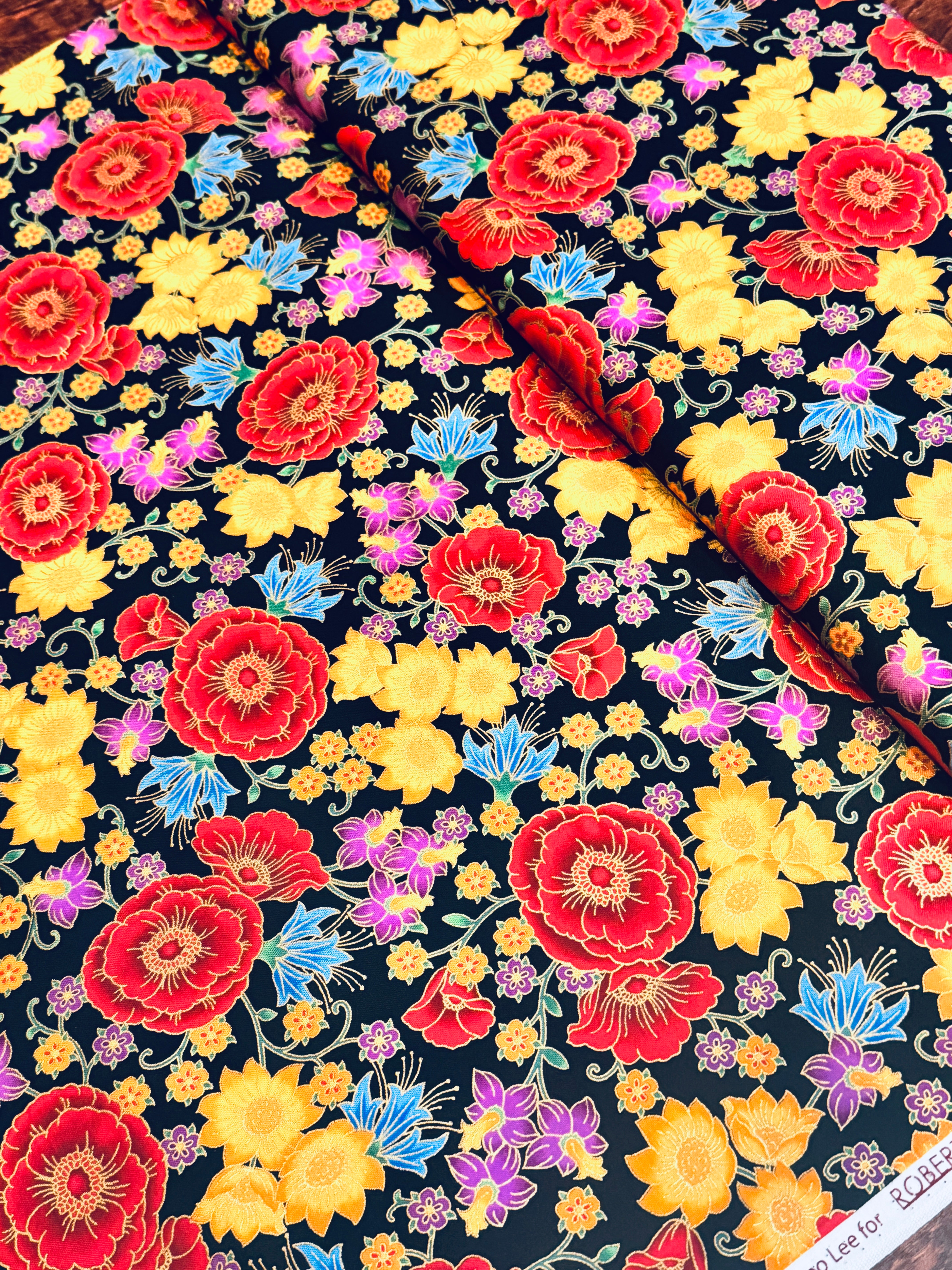 Florentine Garden Floral Multi Metallic cotton fabric by Hyun Joo Lee for Robert Kaufman featuring vibrant red, gold, purple, and blue flowers with metallic accents on a black background.