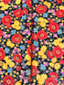 Florentine Garden Floral Multi Metallic cotton fabric by Hyun Joo Lee for Robert Kaufman featuring vibrant red, gold, purple, and blue flowers with metallic accents on a black background.