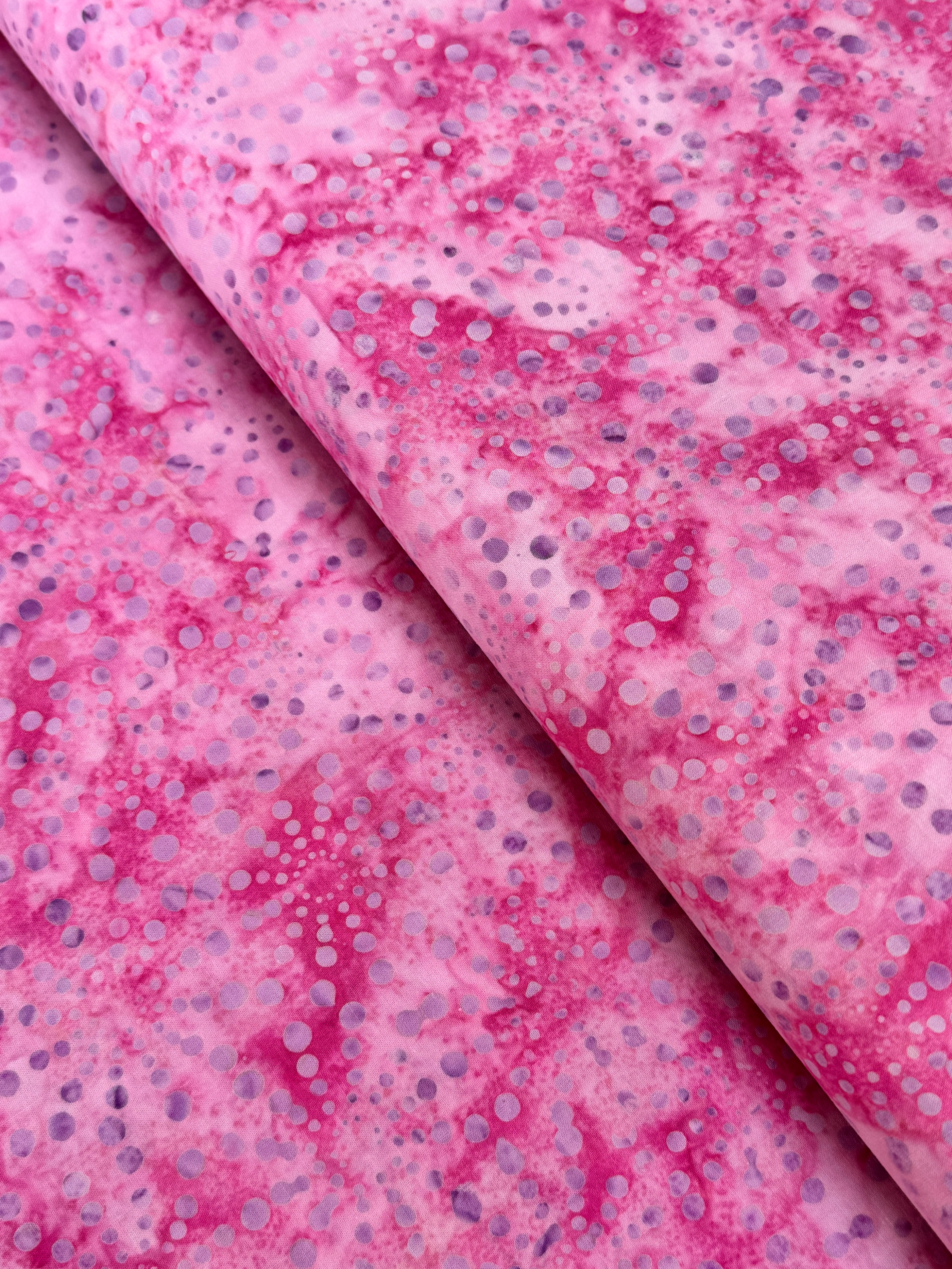 Bursts Rose Batik Fabric by Jinny Beyer – hand-dyed pink cotton batik with subtle bursts from Malam Batiks VIII by RJR Fabrics.