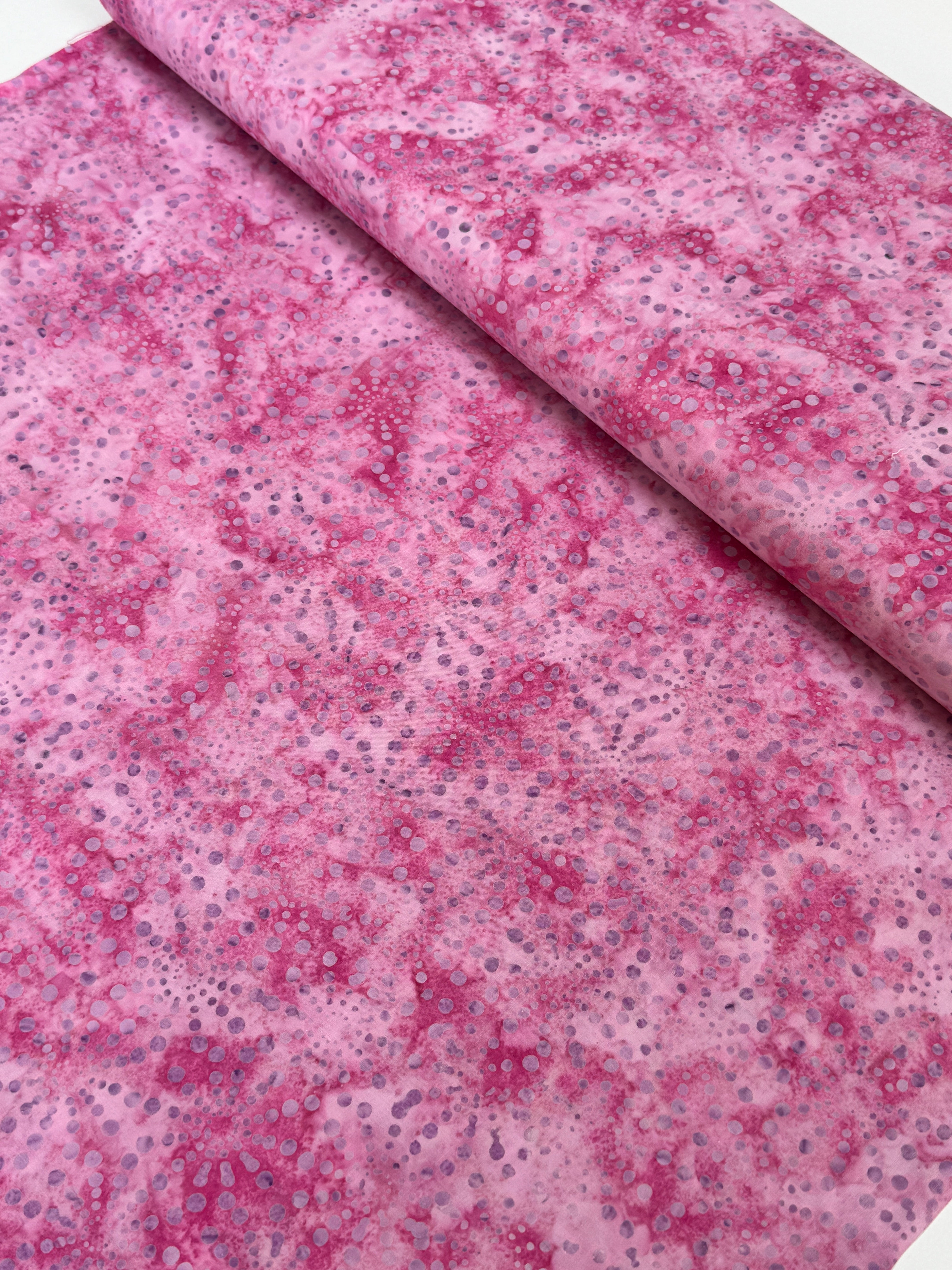 Bursts Rose Batik Fabric by Jinny Beyer – hand-dyed pink cotton batik with subtle bursts from Malam Batiks VIII by RJR Fabrics.