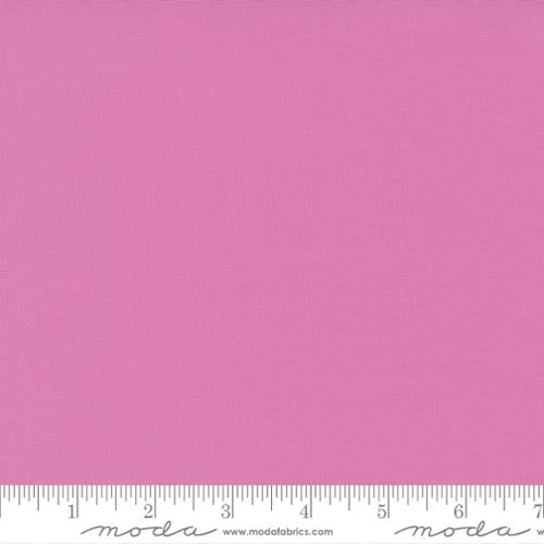 Bella Solids Sweet Pea fabric by Moda Fabrics featuring a soft sweet pea pink premium solid quilting cotton.