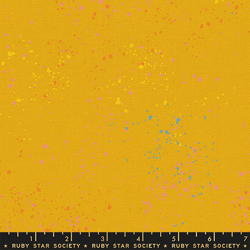 Ruby Star Society Speckled Splatter Paint Goldenrod cotton linen canvas featuring coral, pink, turquoise, yellow, and tonal speckles on a vibrant goldenrod background by Rashida Coleman-Hale for Moda Fabrics.