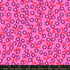 Pink floral fabric with smiling blossoms and coral vines