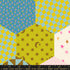 Colorful hexagon patchwork wide quilt backing fabric with whimsical florals, moons, birds, stars, and geometric prints