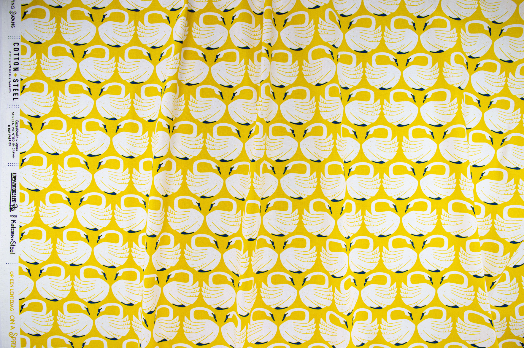 On a Spring Day – Loving Swans – Sundance fabric featuring white swans on a mustard-yellow background by Loes van Oosten for Cotton+Steel.