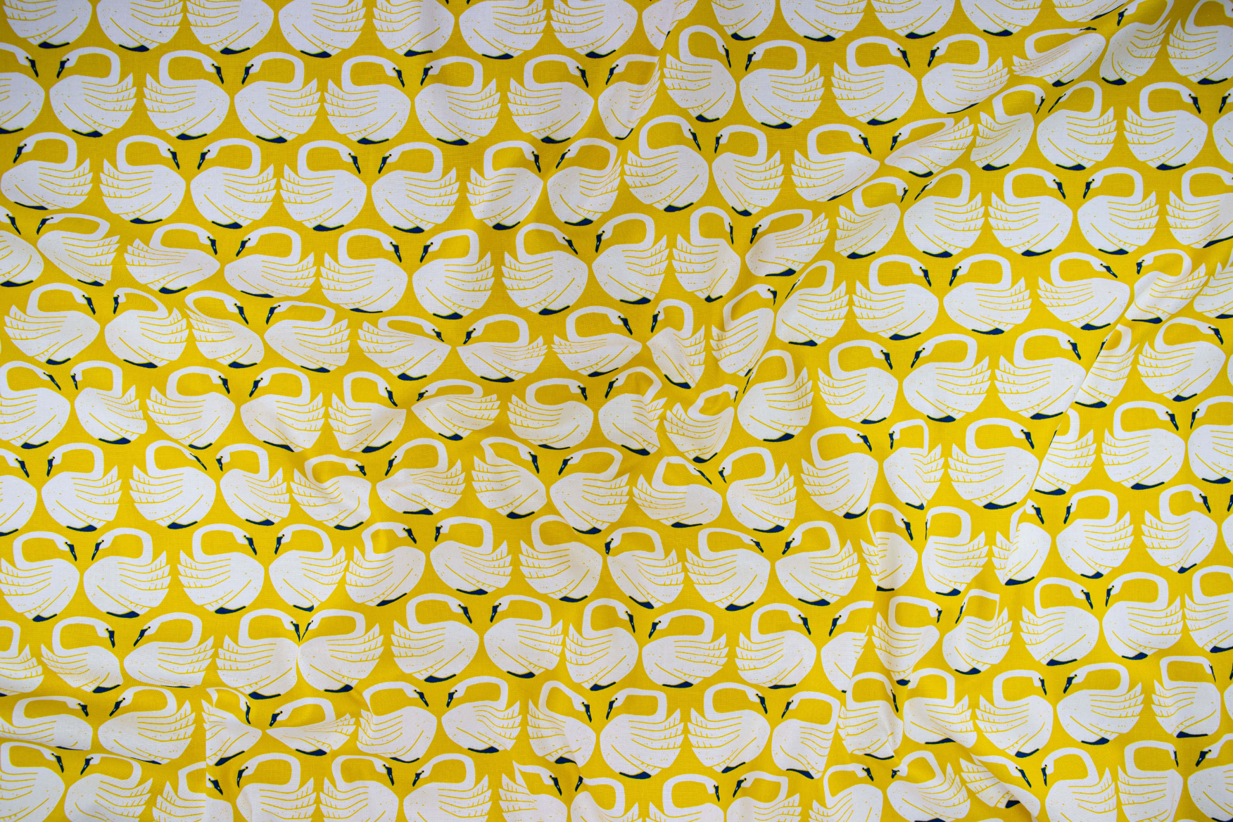 On a Spring Day – Loving Swans – Sundance fabric featuring white swans on a mustard-yellow background by Loes van Oosten for Cotton+Steel.