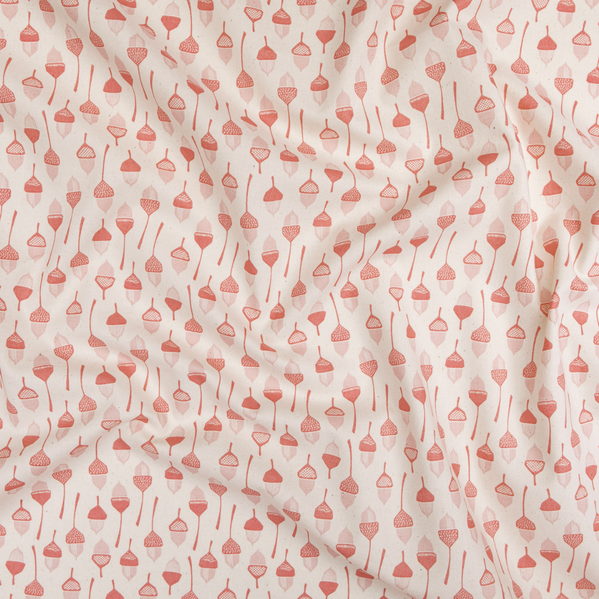 In The Woods – Acorn fabric by Loes Van Oosten featuring coral acorns on unbleached Japanese cotton by Kokka.