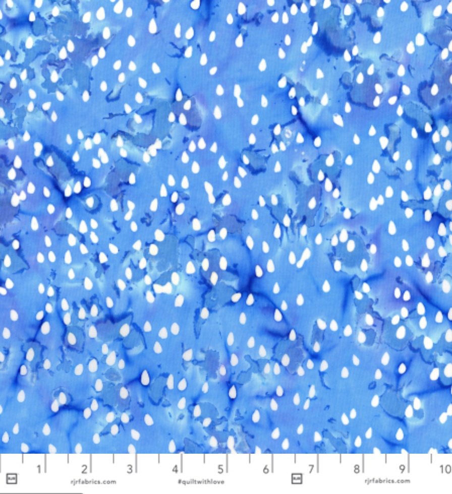 Blossom Batiks Cascade – Raindrops in Cloud by Flaurie & Finch – Soft blue-gray batik fabric with scattered raindrop design.