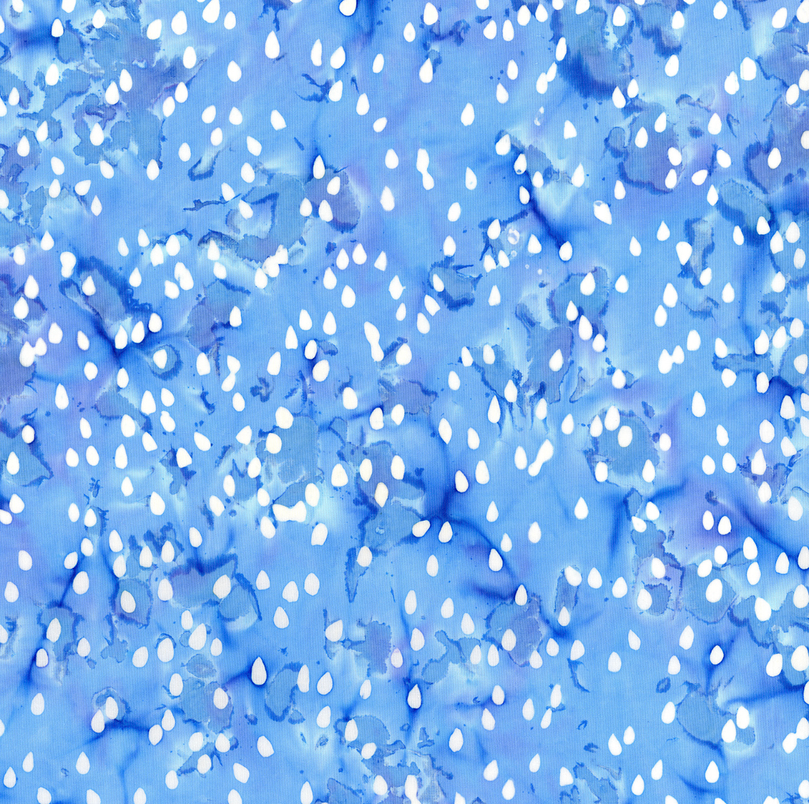Blossom Batiks Cascade – Raindrops in Cloud by Flaurie & Finch – Soft blue-gray batik fabric with scattered raindrop design.