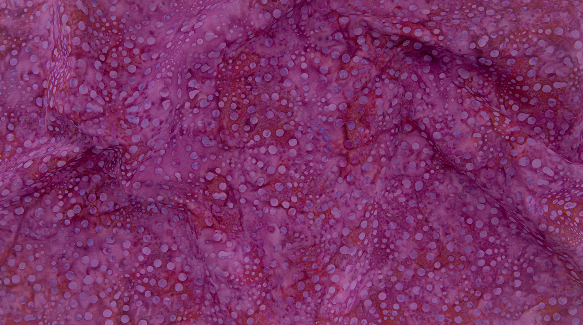 Bursts Pink Batik Fabric by Jinny Beyer – hand-dyed cotton batik in bright pink from Malam Batiks VIII for RJR Fabrics.