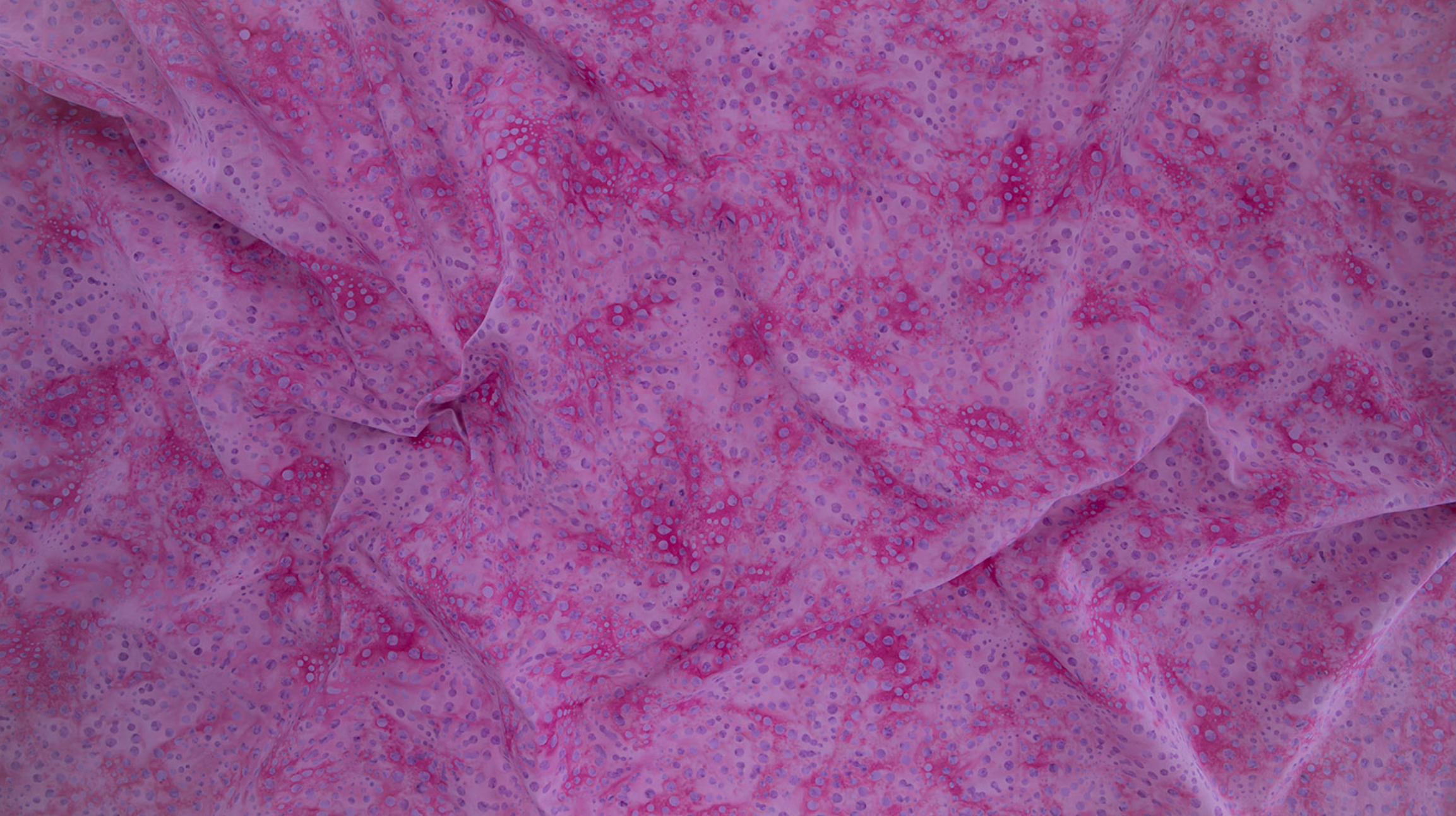 Bursts Rose Batik Fabric by Jinny Beyer – hand-dyed pink cotton batik with subtle bursts from Malam Batiks VIII by RJR Fabrics.