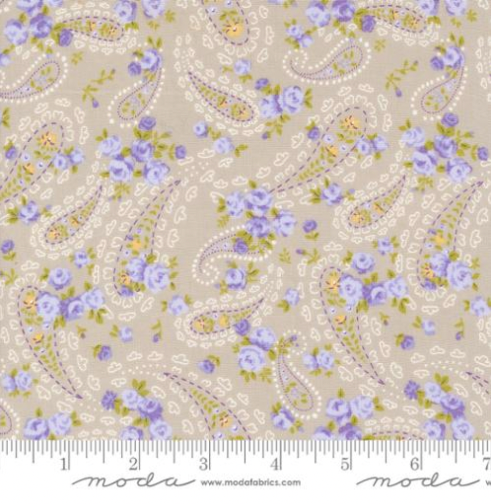 Close-up of Georgia Paisley Stone Fabric by Brenda Riddle for Moda Fabrics featuring lavender floral paisley design on a stone background.