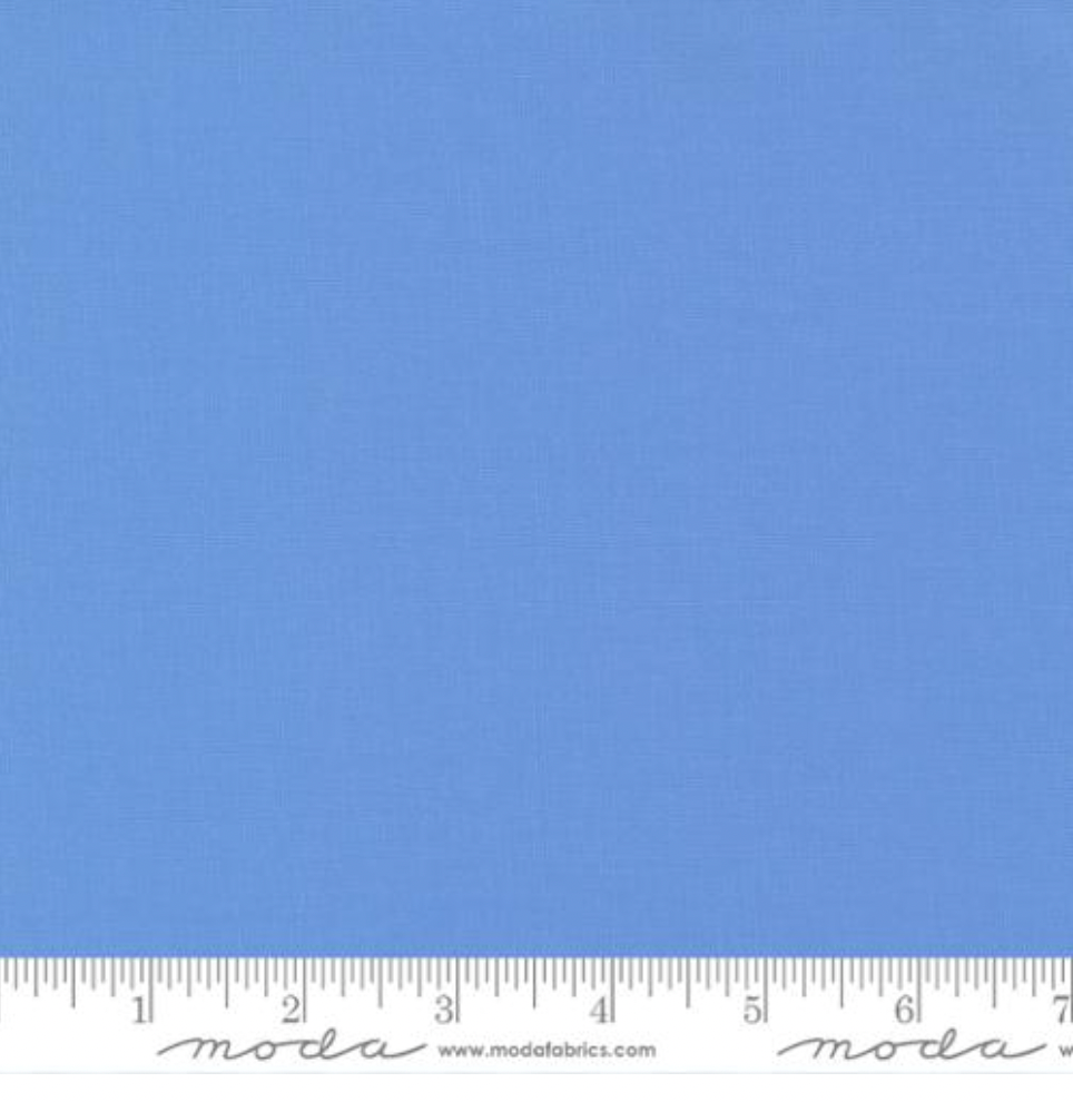 Bella Solids 30’s Blue Fabric by Moda Fabrics – soft mid-tone blue 100% cotton quilting fabric shown with smooth weave texture.