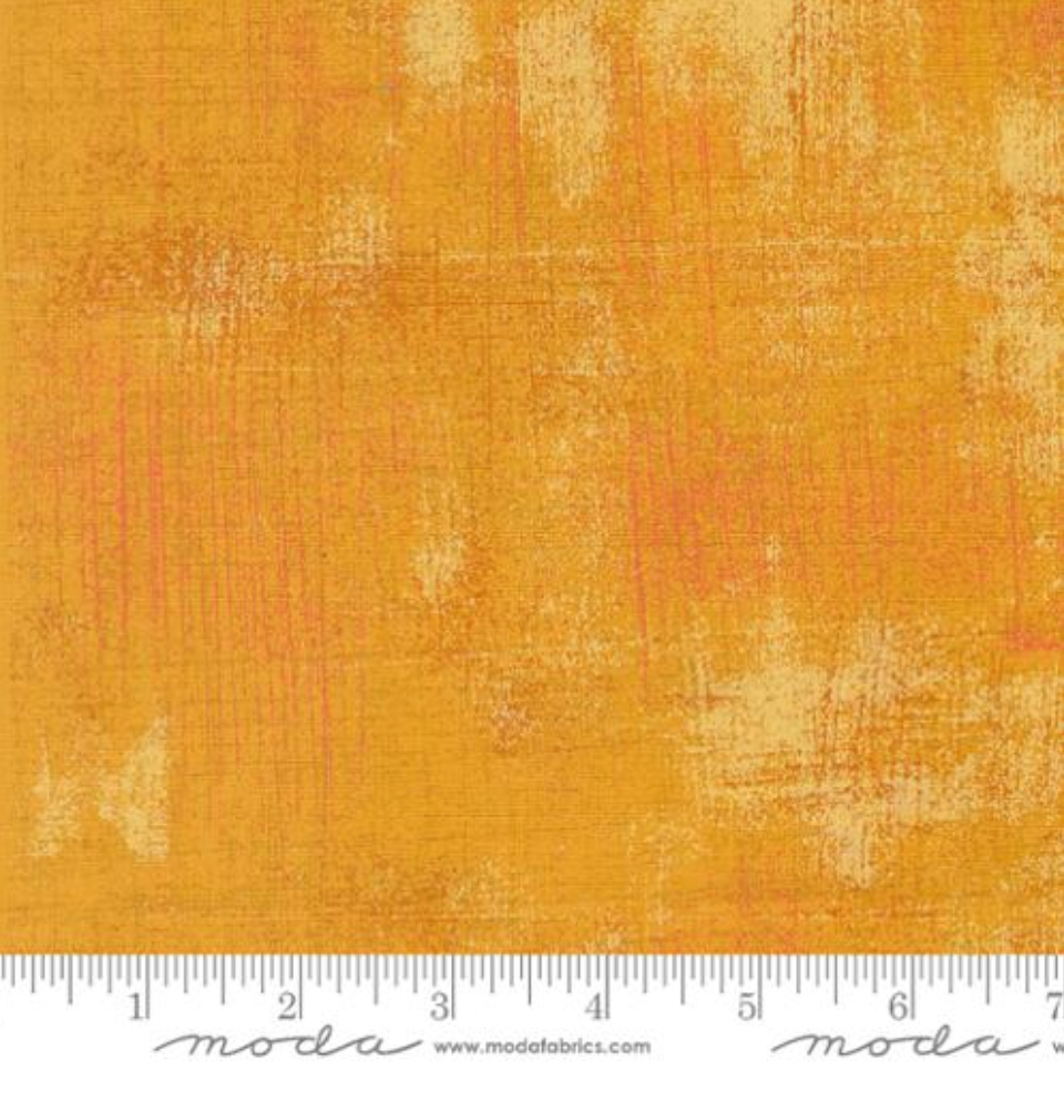 Close-up of Grunge Basics OJ Fabric by BasicGrey for Moda Fabrics showing orange tonal brushstroke texture on cotton quilting fabric.