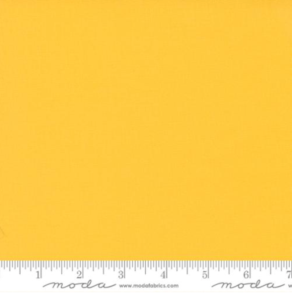 Bella Solids Yellow Fabric by Moda Fabrics – bright solid yellow 100% cotton quilting fabric with smooth matte texture.