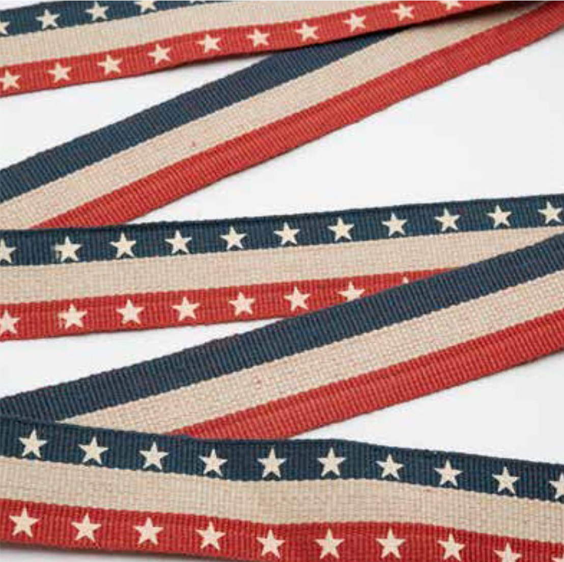 1-inch red, white, and blue Americana twill tape ribbon with stars and stripes on a 25-yard roll by Moda Fabrics.