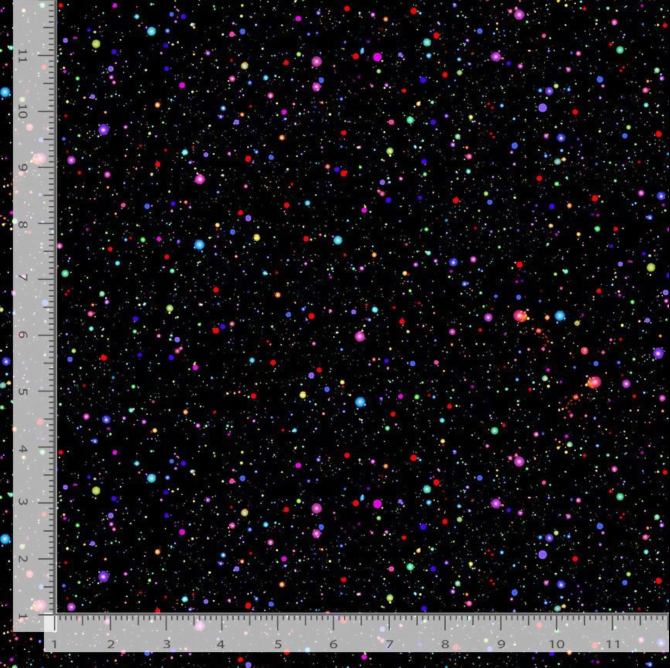 Rainbow confetti dots scattered on a black cotton fabric background.