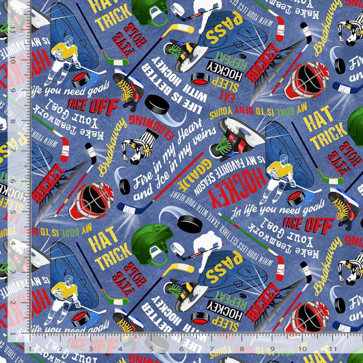 Hockey Star text cotton fabric with hockey gear and phrases on a denim blue background by Timeless Treasures
