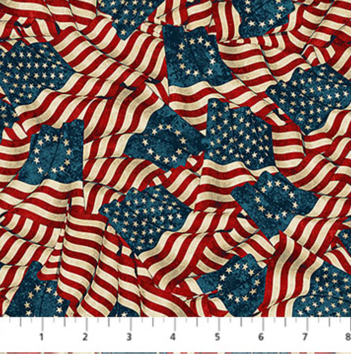 America 250 Stonehenge Flags Beige Multi Backing fabric featuring flowing American flags in red, ivory, and navy on a textured patriotic background.