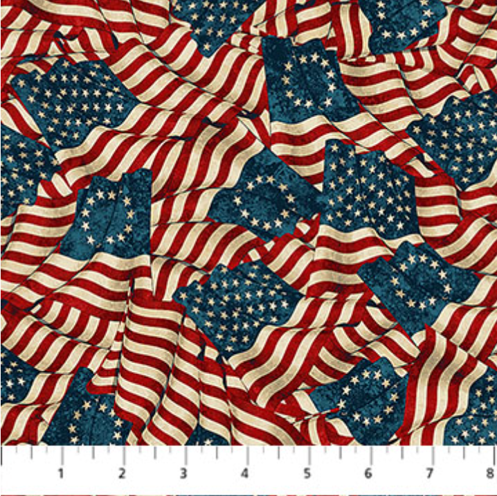 America 250 Stonehenge Flags Beige Multi fabric featuring flowing American flags in red, ivory, and navy on a textured patriotic background.
