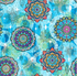 Colorful mandala fabric featuring vibrant floral medallions in jewel tones on a textured blue background by Blank Quilting.