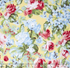 Floral cotton fabric featuring pink roses, blue hydrangeas, and delicate blossoms on a soft butter yellow background from the Simply Chic collection by Anna Stuart for Benartex.