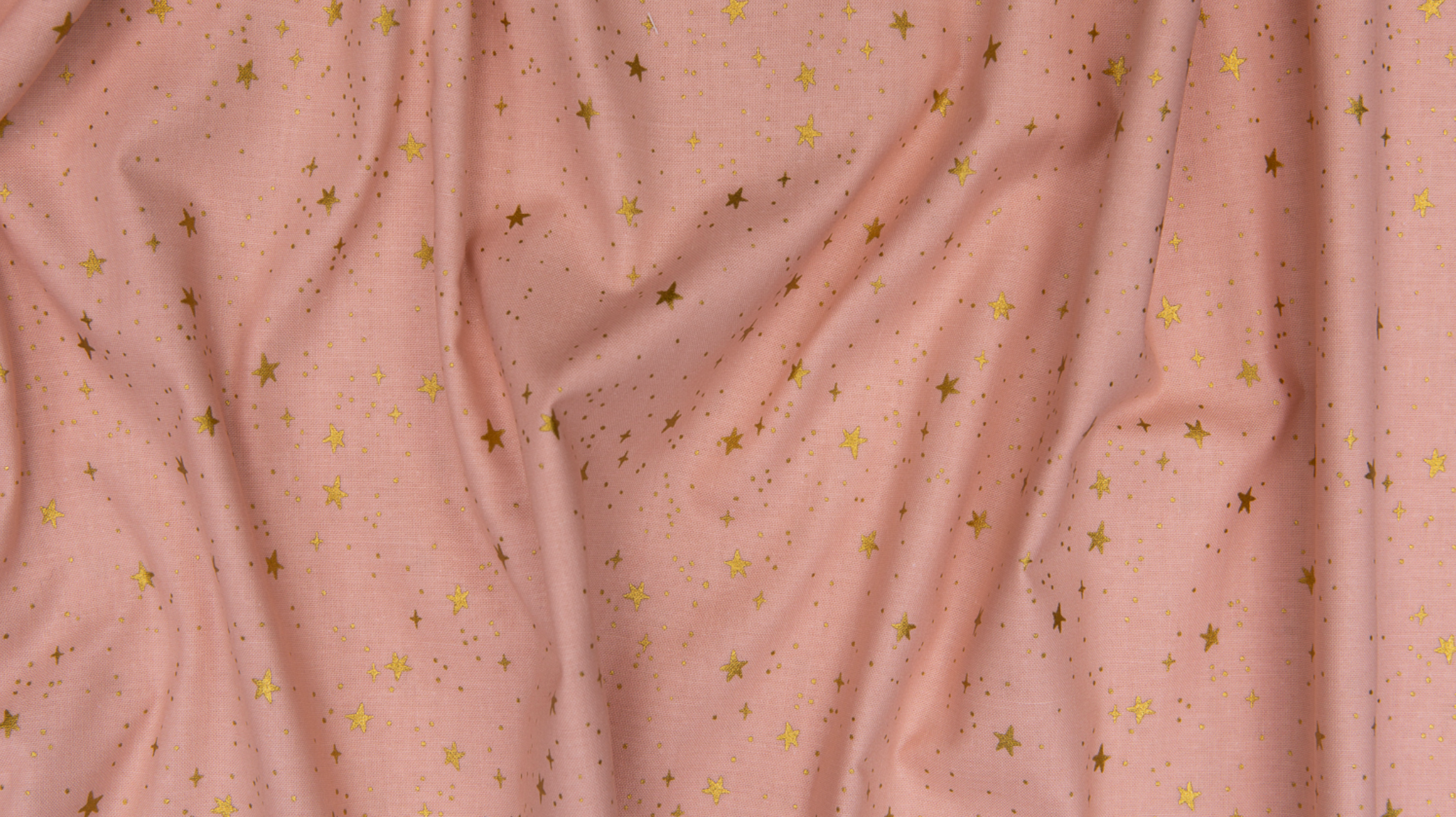 Primavera Stars Blush Metallic fabric by Rifle Paper Co. featuring shimmering metallic gold stars scattered across a soft blush pink background.