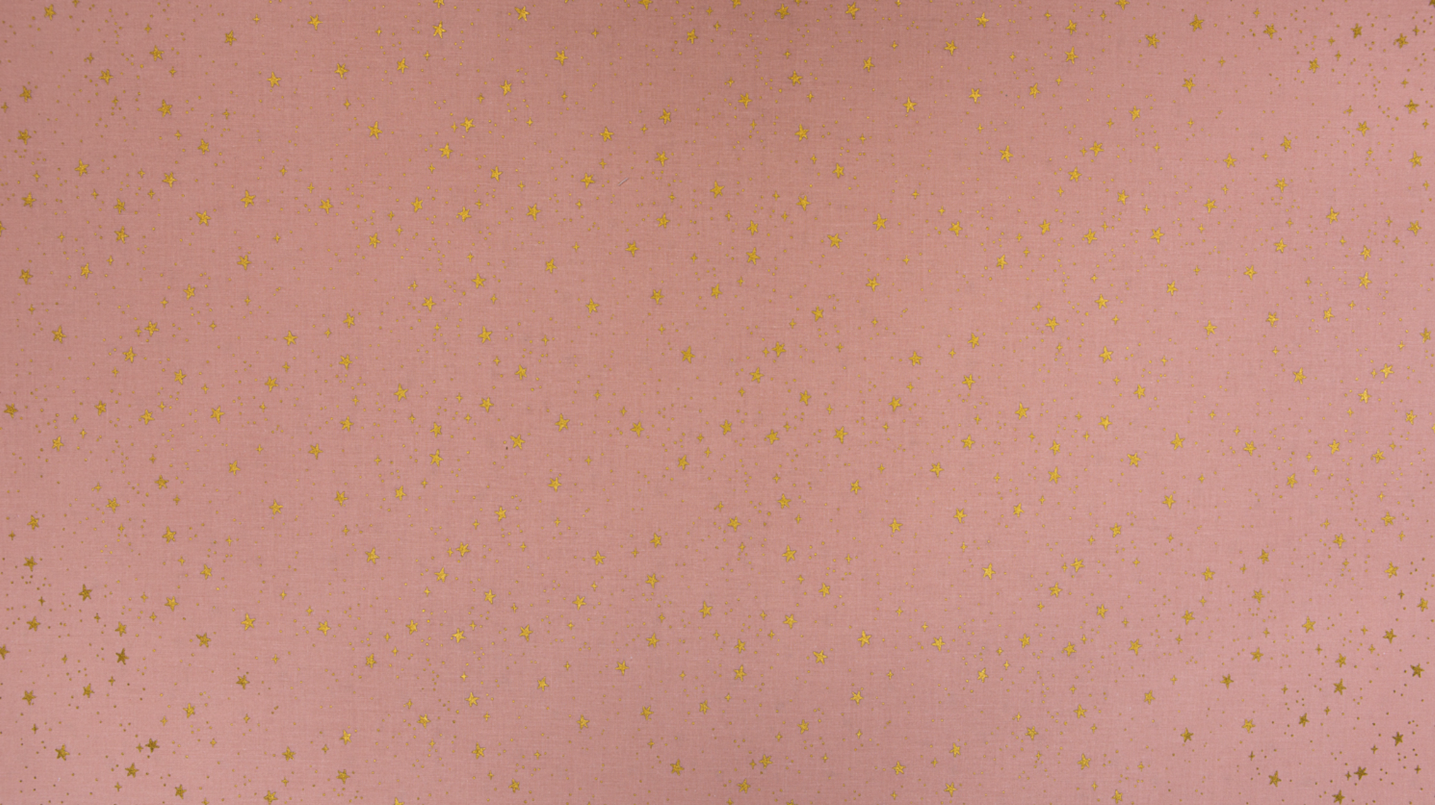 Primavera Stars Blush Metallic fabric by Rifle Paper Co. featuring shimmering metallic gold stars scattered across a soft blush pink background.