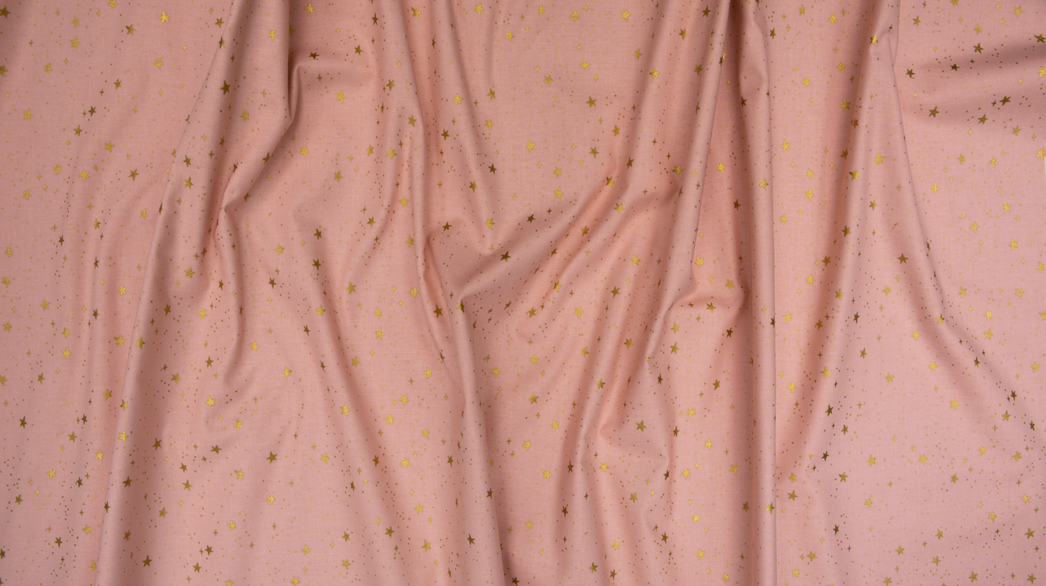 Primavera Stars Blush Metallic fabric by Rifle Paper Co. featuring shimmering metallic gold stars scattered across a soft blush pink background.