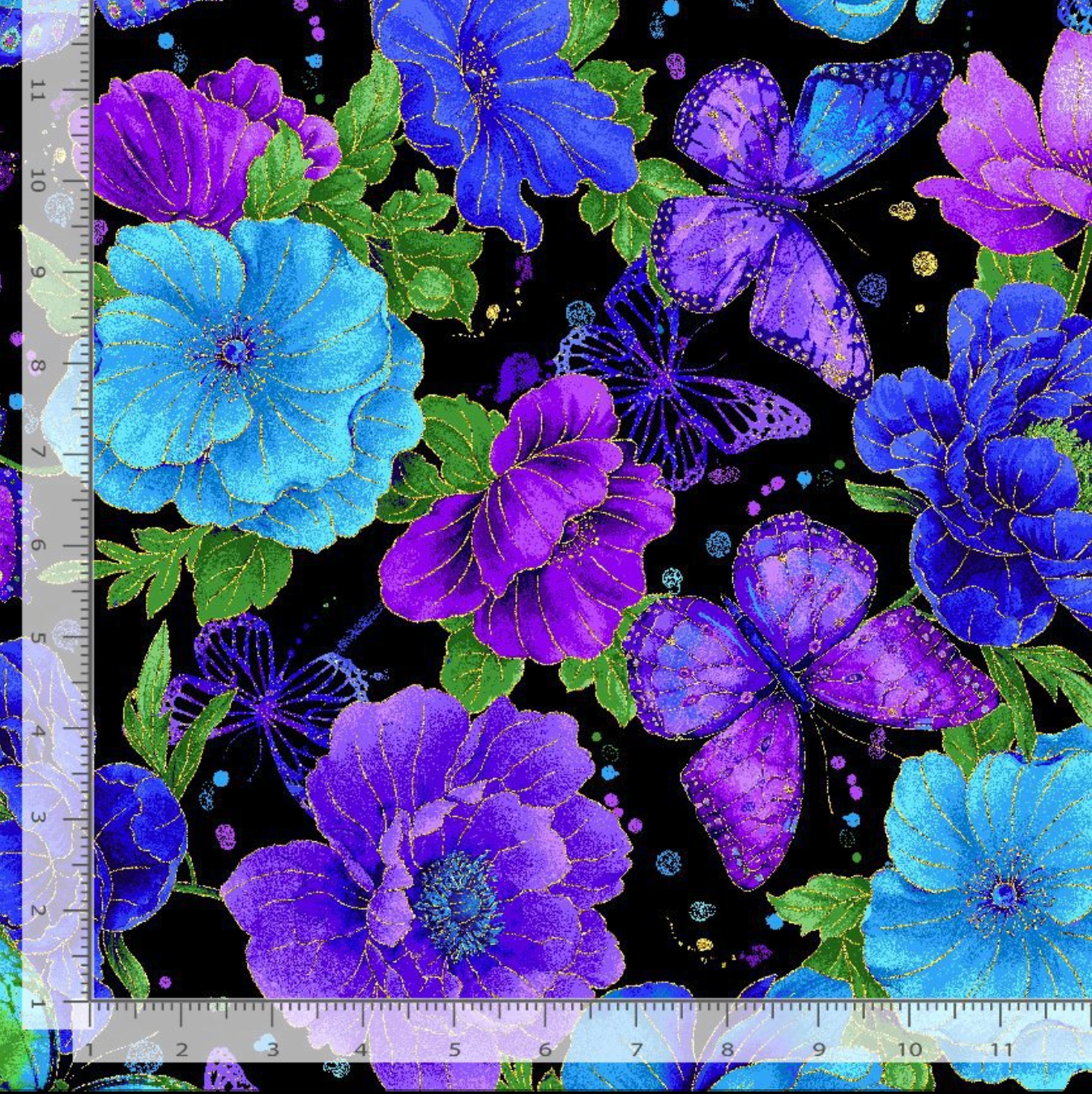 Evening Glow metallic cotton fabric by Chong-A Hwang featuring vibrant blue and purple flowers, butterflies, and gold metallic accents on a black background.