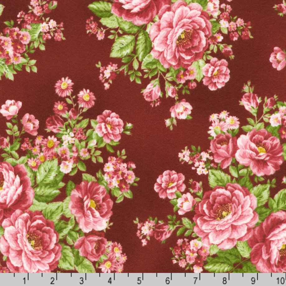 Pink rose bouquets with green leaves on burgundy cotton flannel fabric from the Flowerhouse Collection by Debbie Beaves for Robert Kaufman.