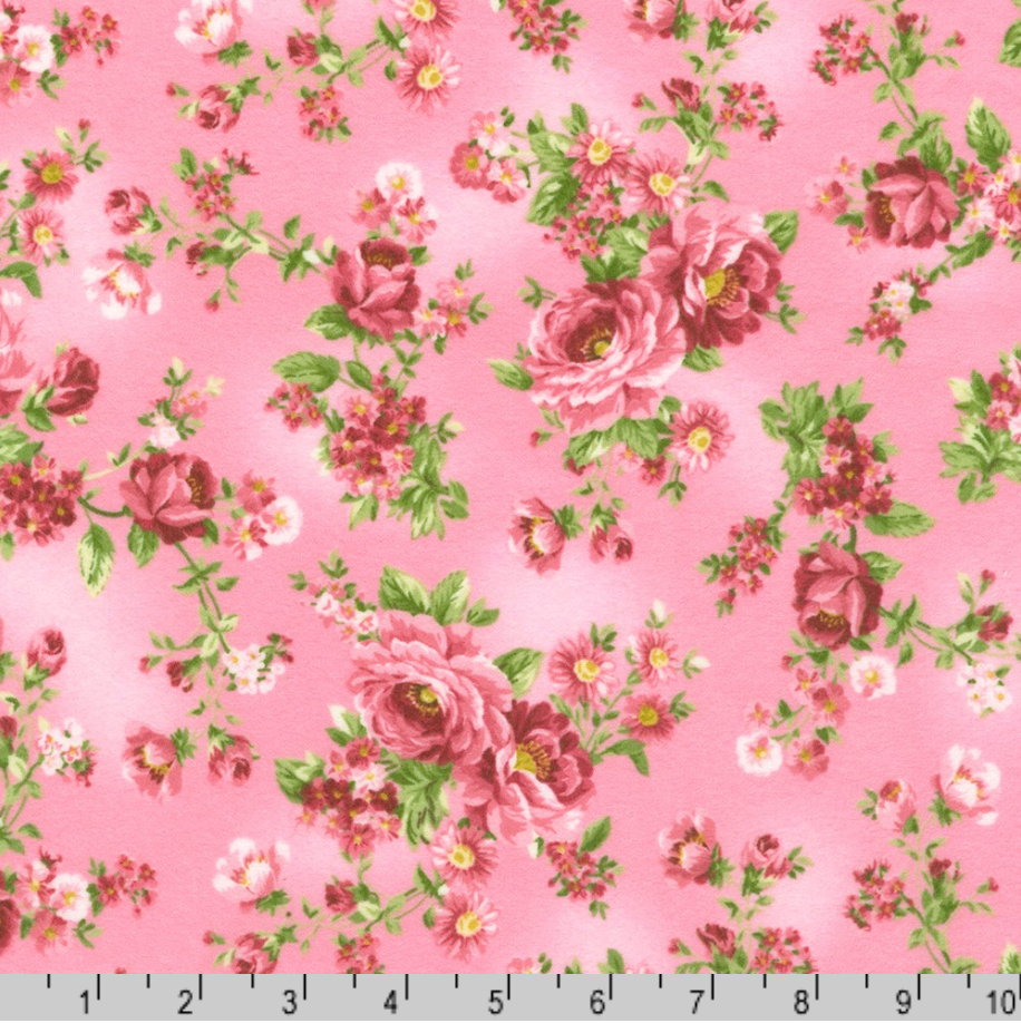 Pink rose bouquets with delicate blossoms on a dahlia pink cotton flannel fabric from the Flowerhouse Collection by Debbie Beaves for Robert Kaufman.