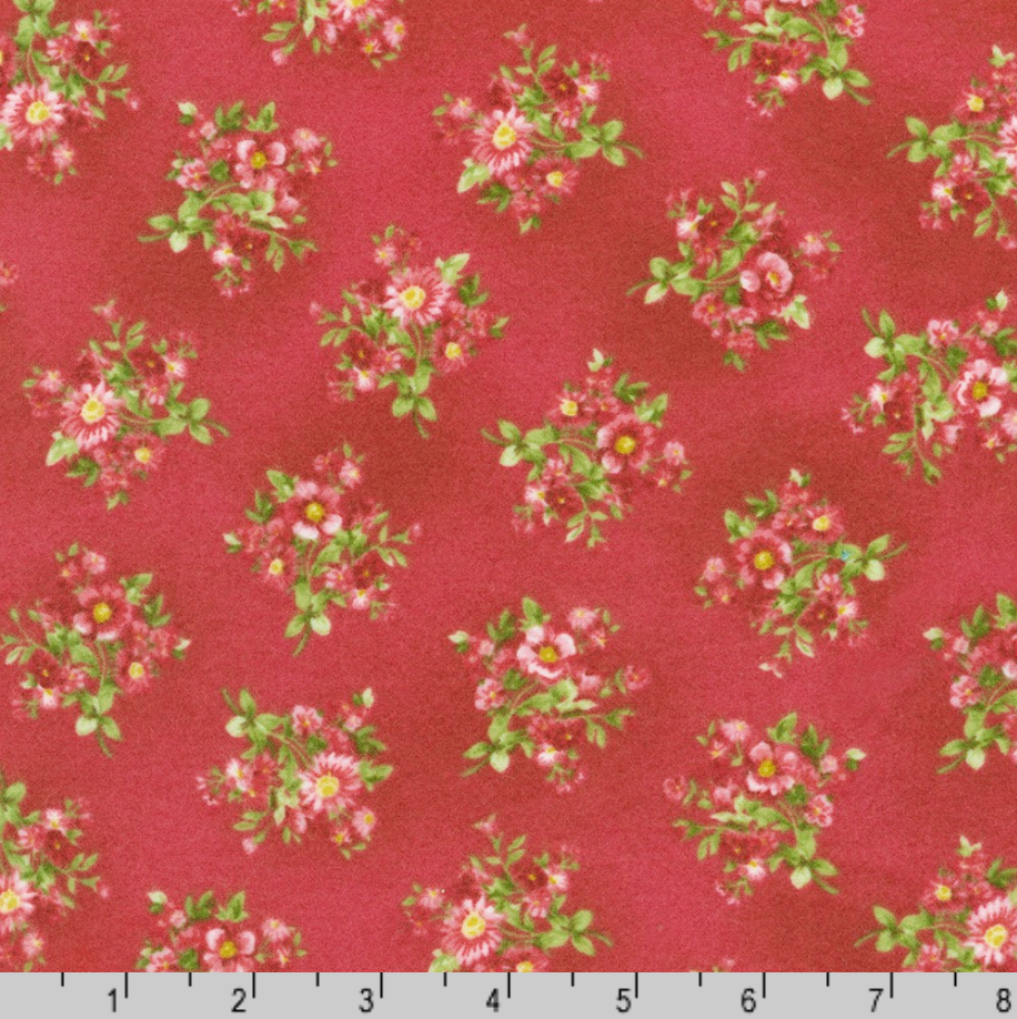 Currant red cotton flannel featuring scattered pink floral posies from the Bouquet of Roses Flowerhouse Collection by Debbie Beaves for Robert Kaufman.