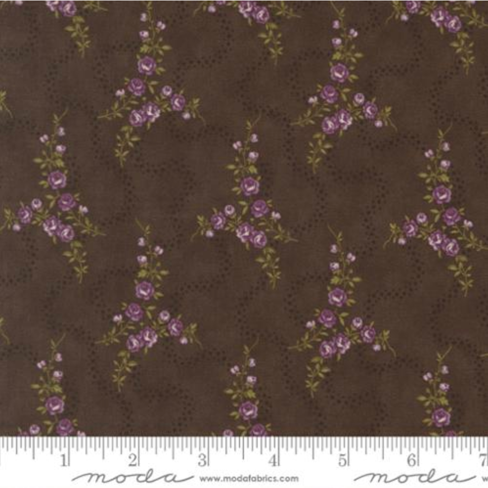 Collections Essence Meandering Path Florals Soil fabric by Howard Marcus for Moda Fabrics featuring delicate lavender floral vines on a rich soil brown premium cotton background.