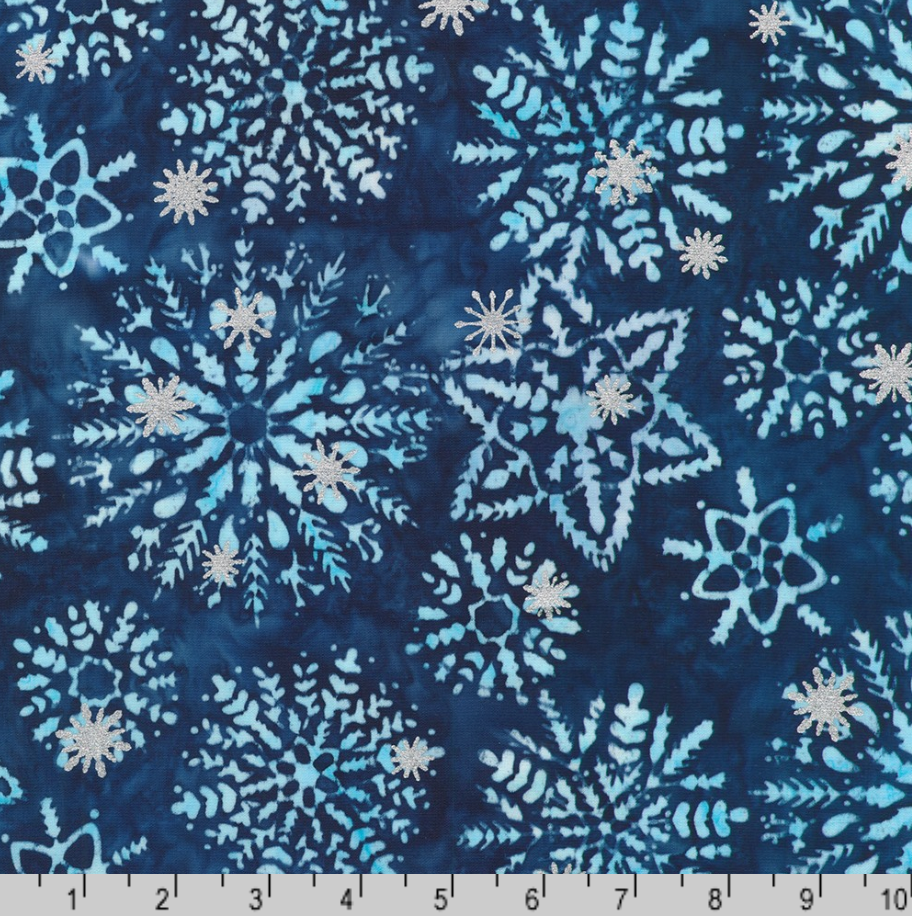 Artisan Batiks Evergreen Ice Sparkle Frosted Snowflakes Blue premium cotton batik featuring large frosted snowflakes with metallic silver accents on a deep navy and icy blue hand-dyed background by Lunn Studios for Robert Kaufman.