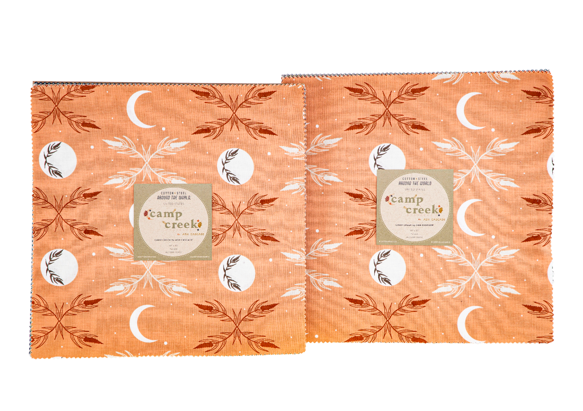 Camp Creek 10x10 Layer Cake by Ash Cascade for RJR Fabrics featuring 42 premium cotton precut squares with woodland, botanical, celestial, floral, and nature-inspired prints in earthy sage, olive, charcoal, peach, mustard, taupe, and blue tones.