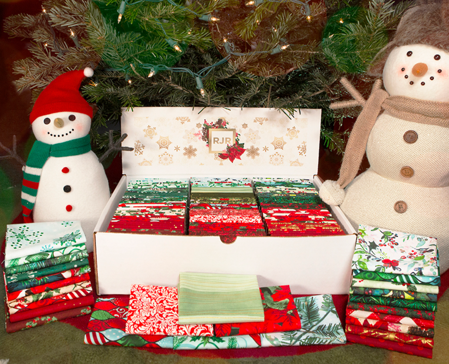 Winter Fat Quarter Box by RJR Studio for RJR Fabrics containing 120 festive red, green, cream and gold Christmas fat quarters.
