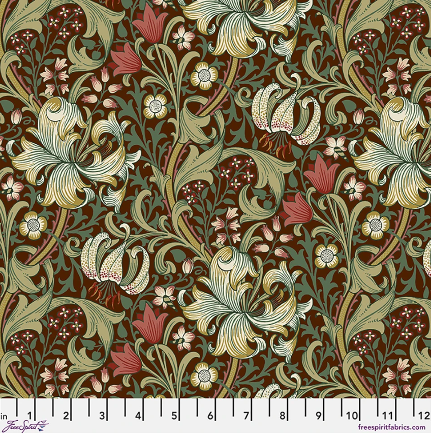 Suffolk Holiday Golden Lily Ruby fabric by Morris & Co for FreeSpirit, featuring cream lilies, sage and teal foliage, blush flowers, and flowing vines on a deep ruby background.