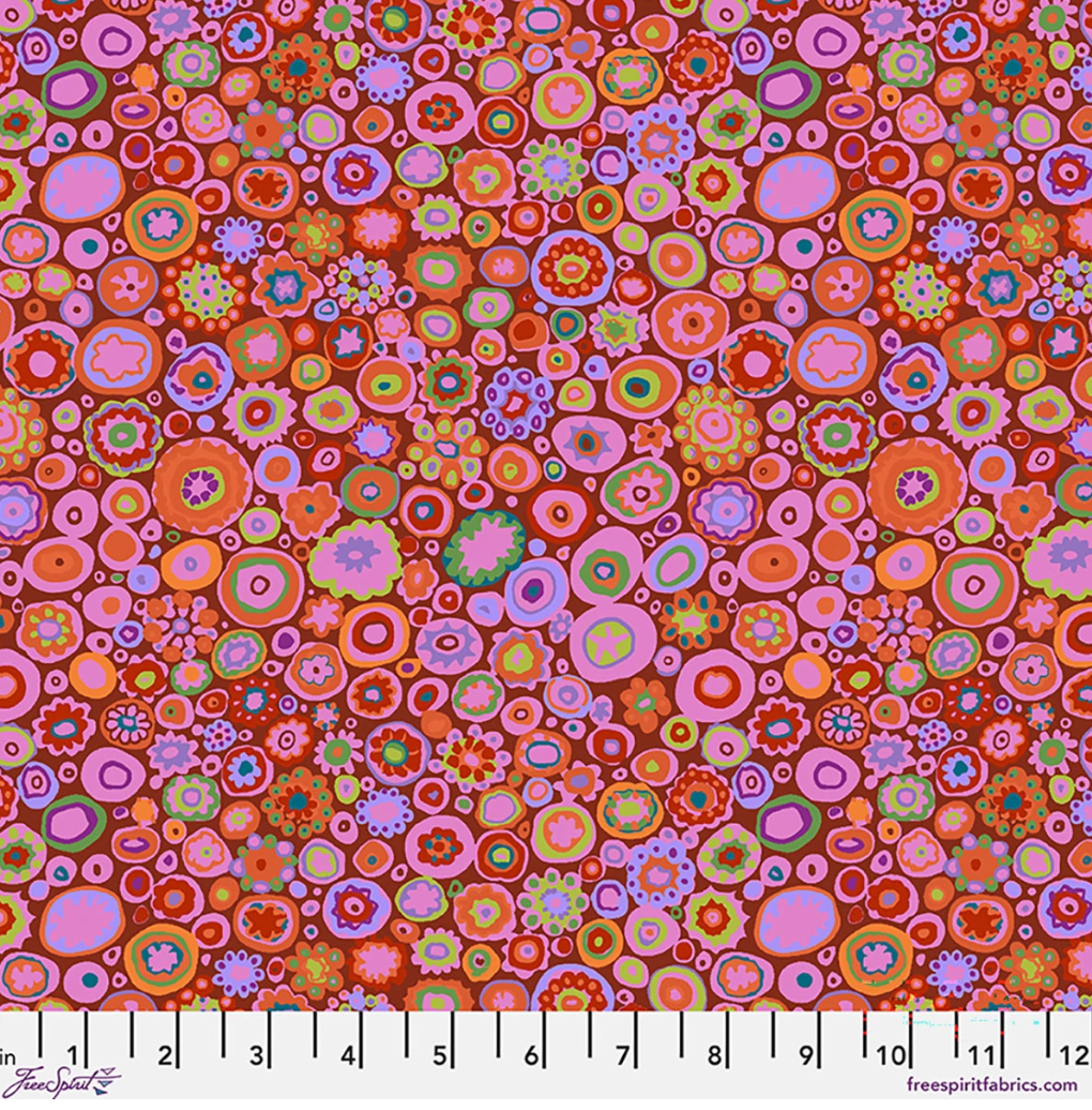 Kaffe Fassett Paperweight Paprika cotton lawn fabric featuring colorful circular and floral motifs in red, orange, pink, purple, green, teal, and lavender.