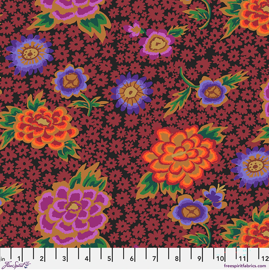 Kaffe Fassett Charlotte Dark cotton lawn fabric featuring large orange, purple, and pink flowers with green leaves over a dark burgundy and black floral background.