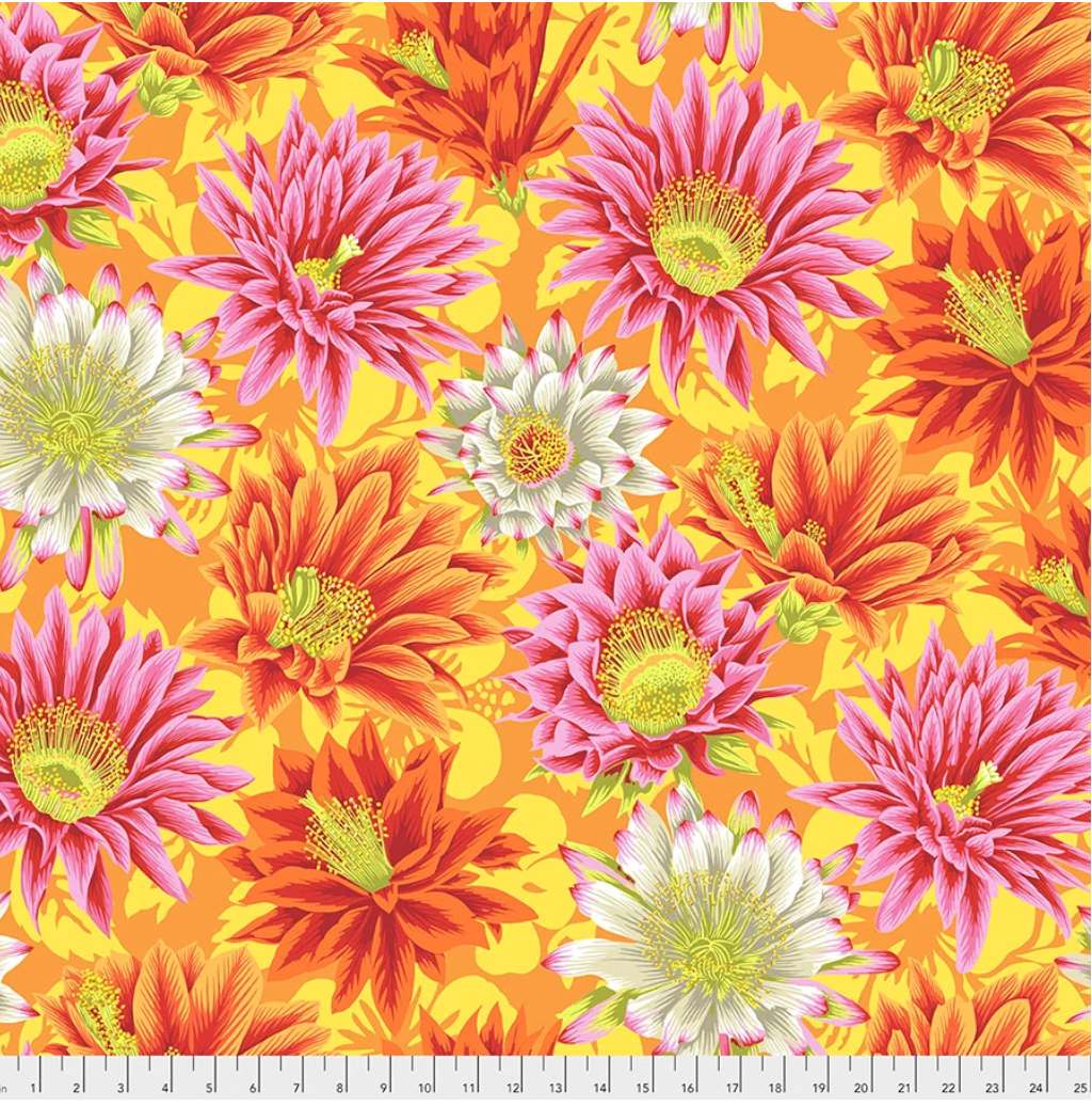 Cactus Flower Yellow fabric by Philip Jacobs for Kaffe Fassett Collective, featuring large pink, coral, orange, red, and cream cactus-inspired flowers on a bright yellow and orange background.