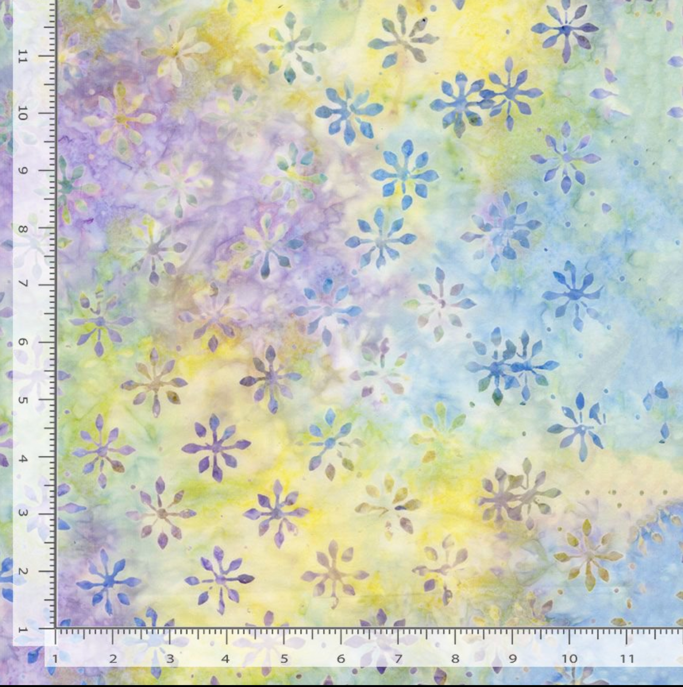 Foulard Dream Tonga Batik fabric by Timeless Treasures featuring scattered floral motifs in pale blue, lavender, yellow, mint green, and cream.