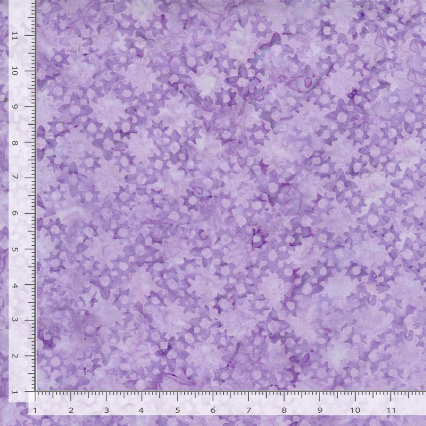 Flower Grove Lilac Tonga Batik fabric by Timeless Treasures featuring small tonal floral shapes in lilac, lavender, violet, and pale purple.