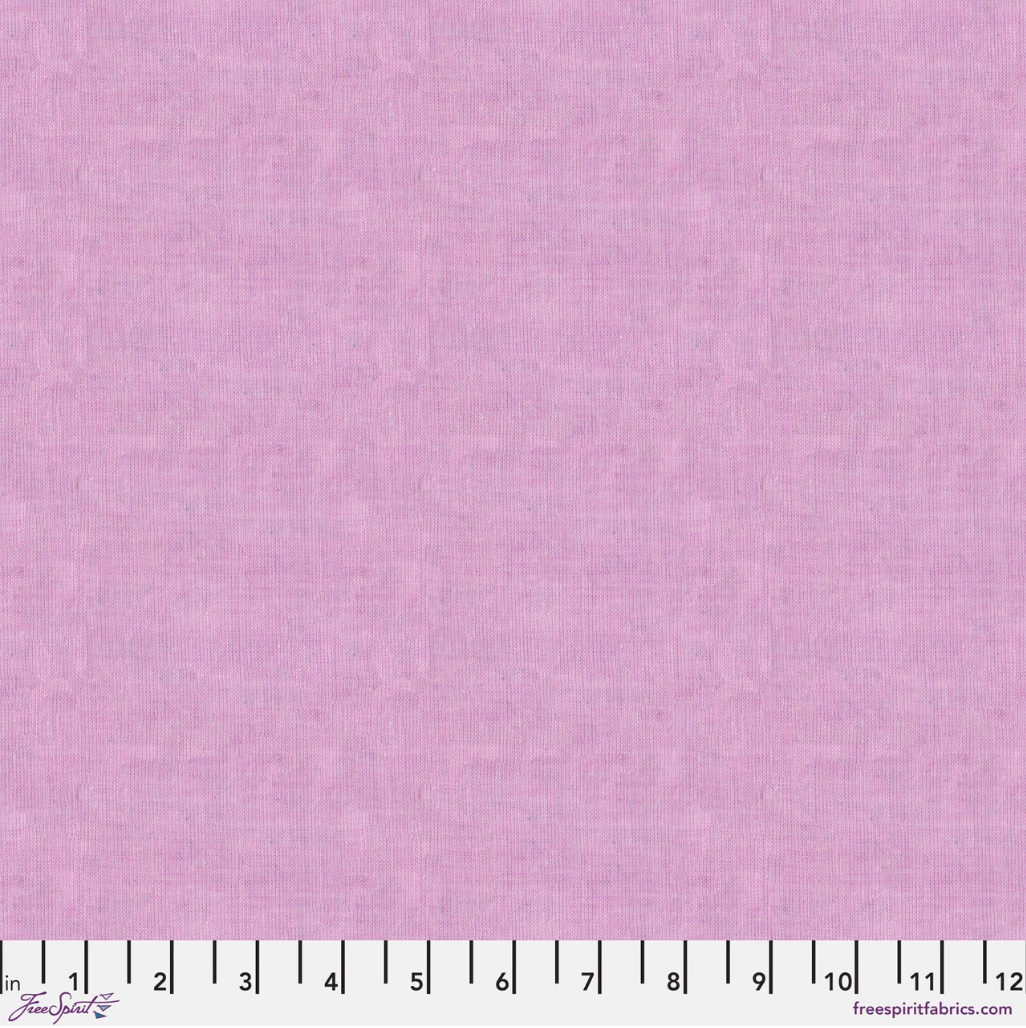 Kaffe Fassett Shot Cotton Dawn fabric by FreeSpirit Fabrics featuring a soft blush pink and lavender woven texture.