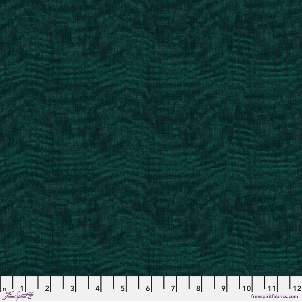 Kaffe Fassett Shot Cotton Bottle fabric by FreeSpirit Fabrics featuring a deep bottle green woven texture with subtle tonal variation.