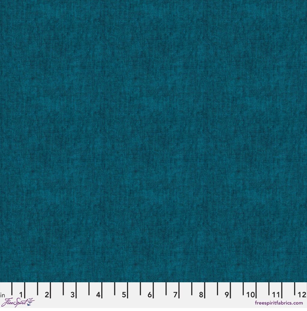 Kaffe Fassett Shot Cotton Peacock fabric by FreeSpirit Fabrics featuring a rich blue-teal woven texture with subtle tonal variation.