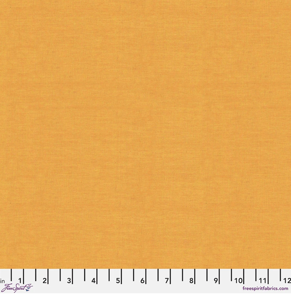 Kaffe Fassett Shot Cotton Butter fabric by FreeSpirit Fabrics featuring a warm buttery yellow-gold woven texture with subtle tonal variation.